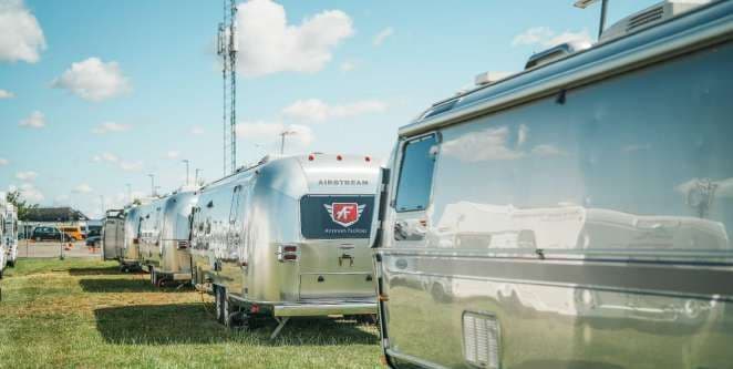 A row of Airstreams among the trees