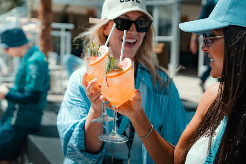 Guests toasting with cocktails at the bar